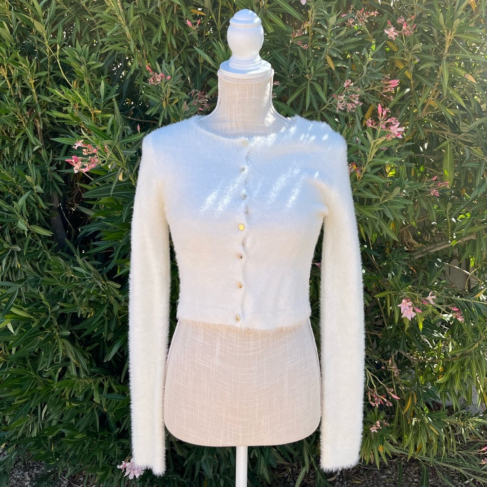 soft white cardigan with gold colored buttons